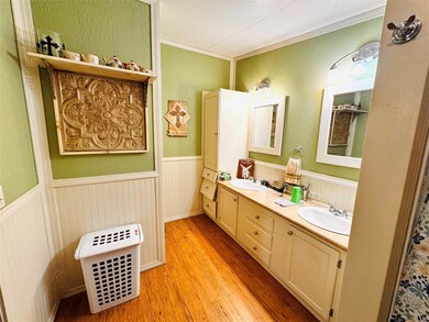 Full bathroom featuring wood finished floors, a si