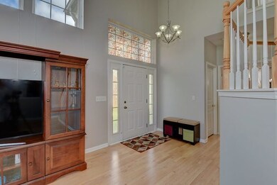 Light and bright foyer with hardwood floors.