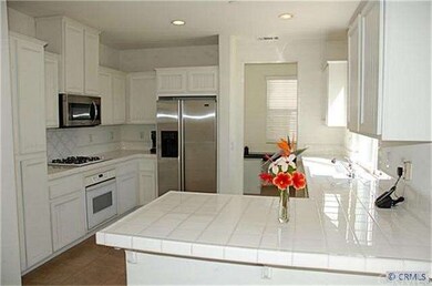 Roomy kitchen with plantation-style cabinetry and 