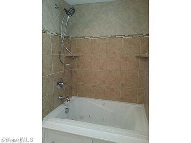 Bath. New jetted tub, tile wainscot and new plumbing fixtures.