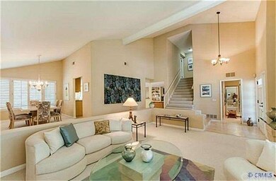 The entry opens to the dramatic vaulted ceilings o