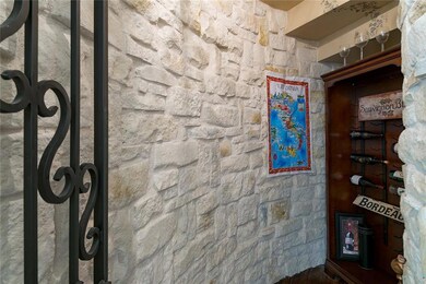 Wine cellar with iron gate off of formal dining.