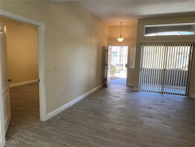 Foyer with light wood-type flooring and baseboards
