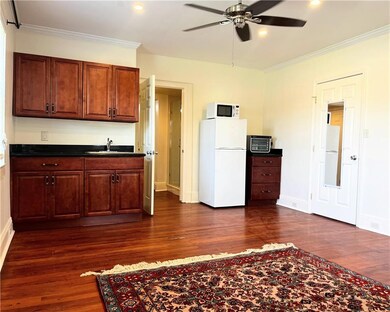 Gorgeous hardwood floors with kitchenette. No range/oven but comes with toaster oven and microwave