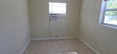 Empty room with baseboards and light tile patterned floors