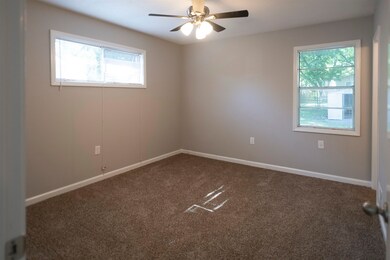 Carpeted empty room with plenty of natural light a
