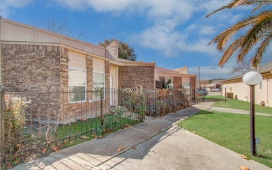Features a view of the neighboring townhomes properties leading down the pathway to the entrance and mailboxes