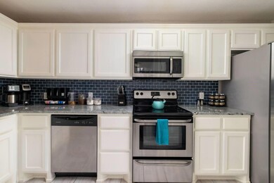 Kitchen with decorative backsplash, fully stocked,