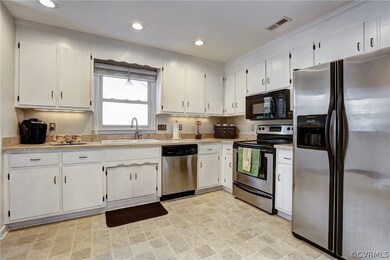 Spacious kitchen with stainless appliances that al