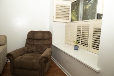Sitting room featuring dark wood-type flooring
