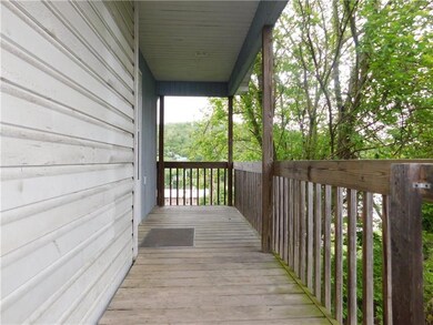 A covered side porch off the kitchen gives you spa