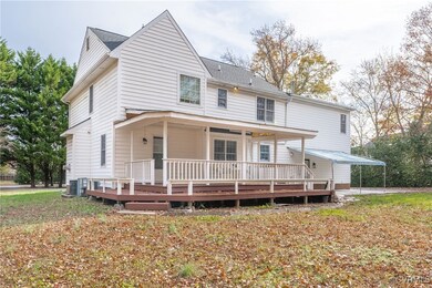 View of front of house with central AC
