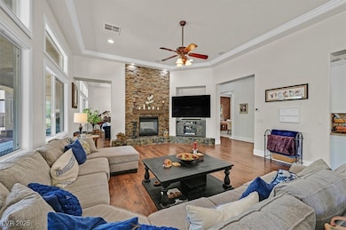 Living area with a ceiling fan, wood finished floo