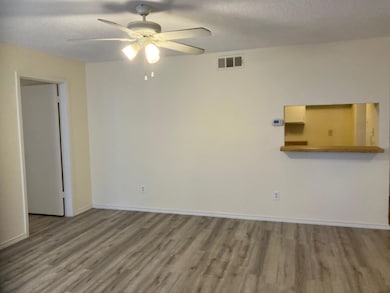 Empty room with hardwood / wood-style floors, a te