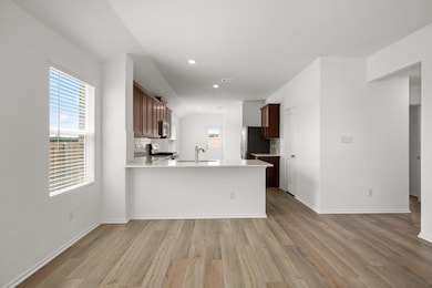 Kitchen featuring a sink, light wood-type floorin
