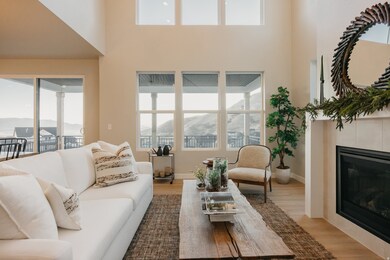Living area featuring a mountain view, wood finished floors, a fireplace, and a high ceiling