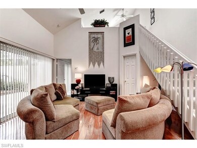 The living room boasts volume ceilings, gorgeous w