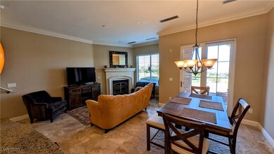 Living room with crown molding, a fireplace, visib