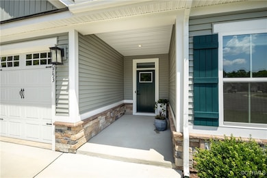 Entrance to property with stone siding