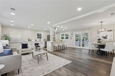 Living room featuring crown molding, dark wood-typ
