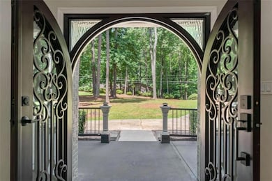View of gate featuring a yard and a porch