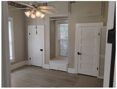 Foyer entrance featuring ceiling fan and wood finished floors