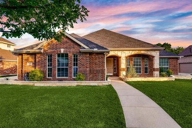 Ranch-style house with a yard and a garage