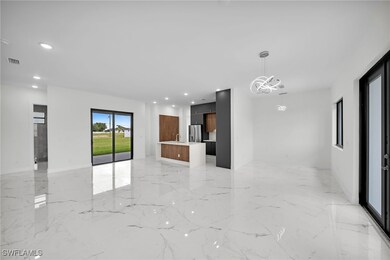 Spare room with sink, an inviting chandelier, and light tile patterned floors