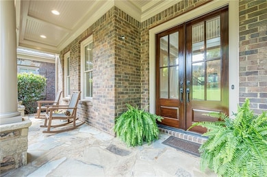 Entrance to property with french doors, covered porch, Stone patio