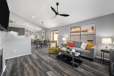 Living room featuring ceiling fan, vaulted ceiling