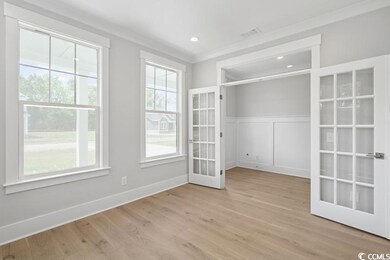 Spare room featuring french doors, light wood-style floors, and recessed lighting