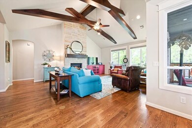 Living room featuring a stone fireplace, wood-type