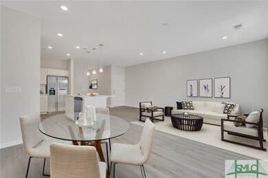 Virtually staged kitchen, dining and living room.