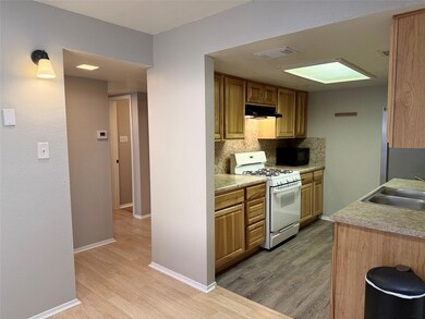 Kitchen with white range with gas cooktop, under 
