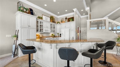 Custom cabinets with glass displays and granite to
