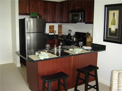Kitchen has eat-in counter, granite counters, stai