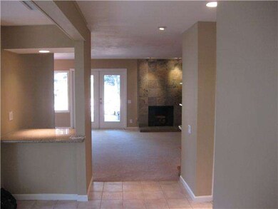 View of fireplace in family room from front door/f