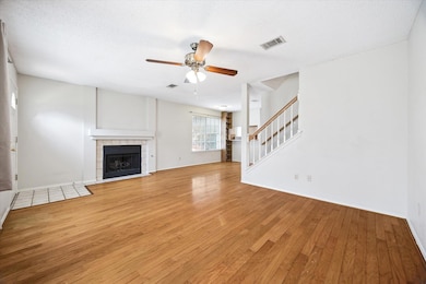 Unfurnished living room with stairway, a tile fir