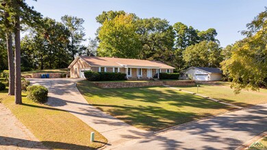 Ranch-style home featuring a garage, a porch, and 