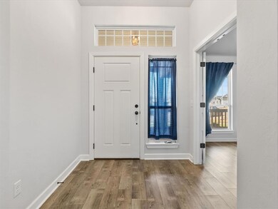 Foyer entrance featuring hardwood / wood-style flo