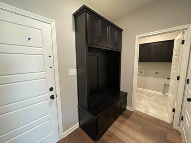 Mudroom with wood finished floors and baseboards
