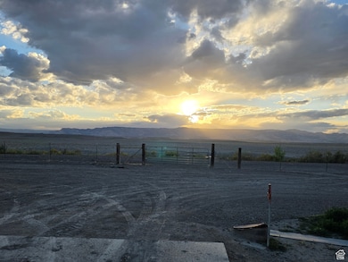 View of road featuring a view of rural / pastoral area, a mountain view, and a gate