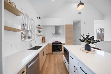 Side view of kitchen features two toned cabinetry