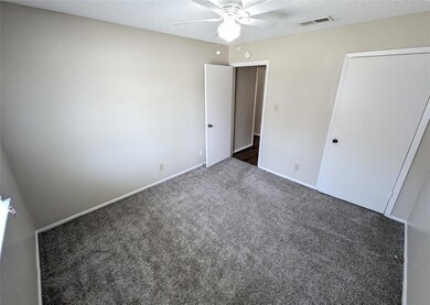 Unfurnished bedroom with carpet, baseboards, a te