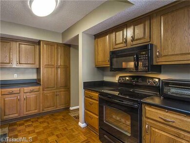 Kitchen. Appliances include a smooth top range, built-in microwave and dishwasher.