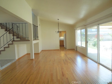 Living room looking to dining room and kitchen beyond. Stairs to left.