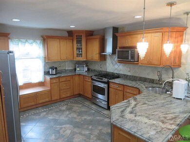 Kitchen has tile floor, granite counter tops, plen