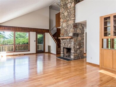 open floor plan with massive stone fireplace