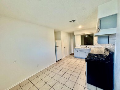 Kitchen with black range with gas stovetop, frees