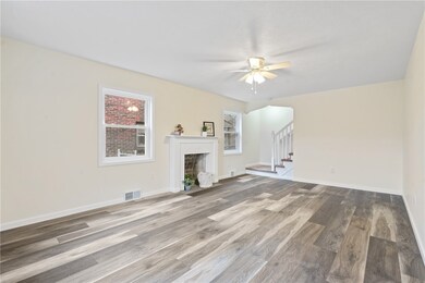 Spacious living room with decorative fireplace.